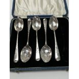 Five bright cut silver spoons, cased. Weighing alt