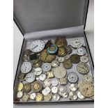 A box contains vintage watch movements, no reserve