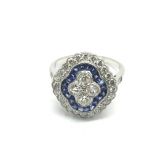 A platinum, sapphire and diamond ring set with fou