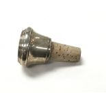 A silver bottle stopper.