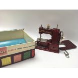 A Vintage Vulcan senior child's sewing machine wit