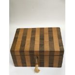 A Satinwood and rosewood striped stationary box -