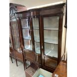 An Edwardian display canbinet with curved front gl