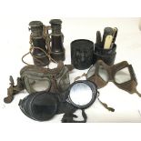 Three pairs of old flying goggles a pair of binoculars and a traveling cutlery set. (a lot)