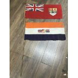Two naval tiller flags. One is the Canadian red en