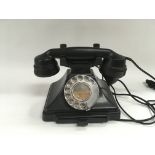 A black bakelite telephone.