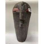 A large carved African tribal mask, 34cm.