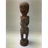 A small tribal African figure possibly Lega Tribe,