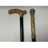 A gilt metal mounted walking stick plus a silver a