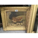 An Antique framed picture depicting a hen and chic