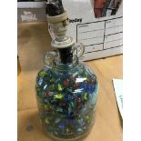 A glass bottle filled with marbles - NO RESERVE