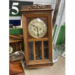 A 1930s walnut wall clock.