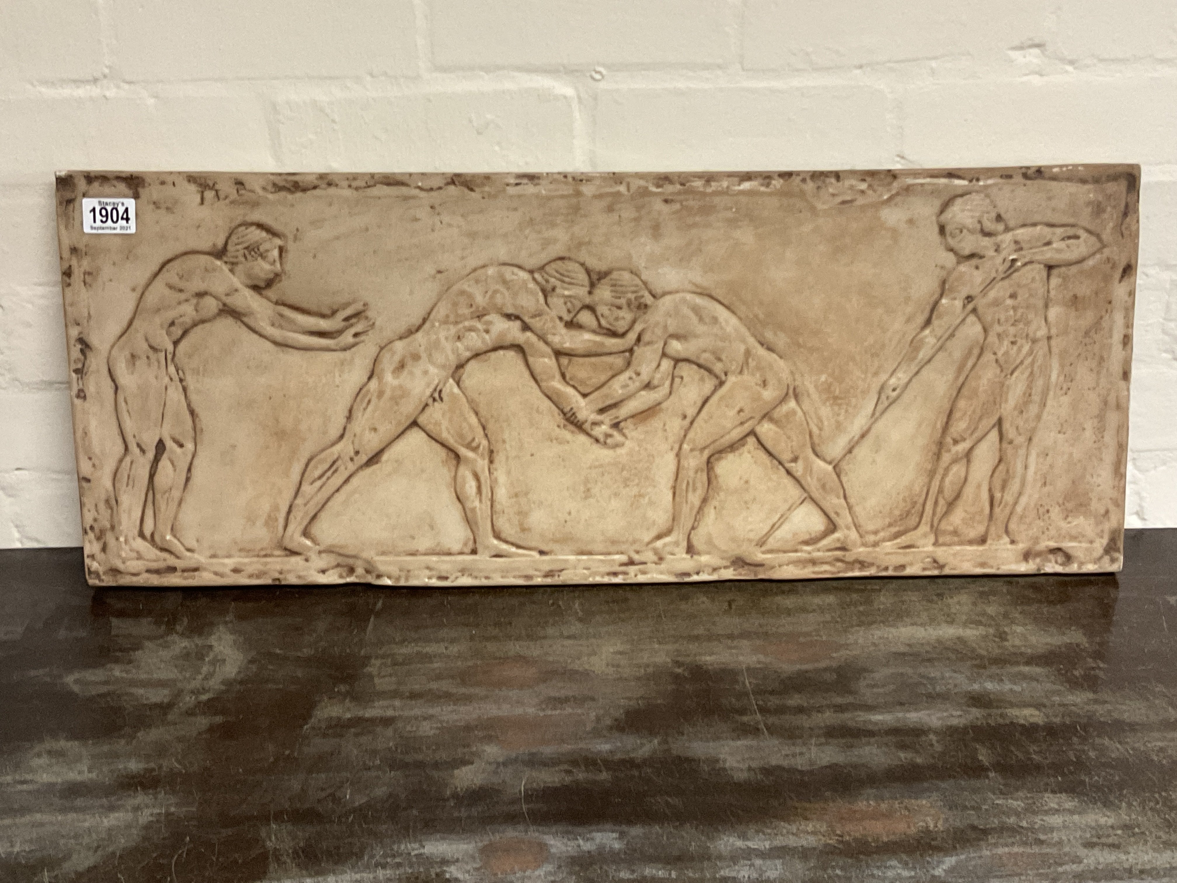 A large Greek style resin plaque. 80 x 32cm.