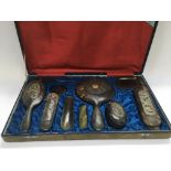 A cased Oriental tortoiseshell dressing table set.