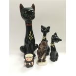 Three ceramic figures of cats, Lomonosov bear and