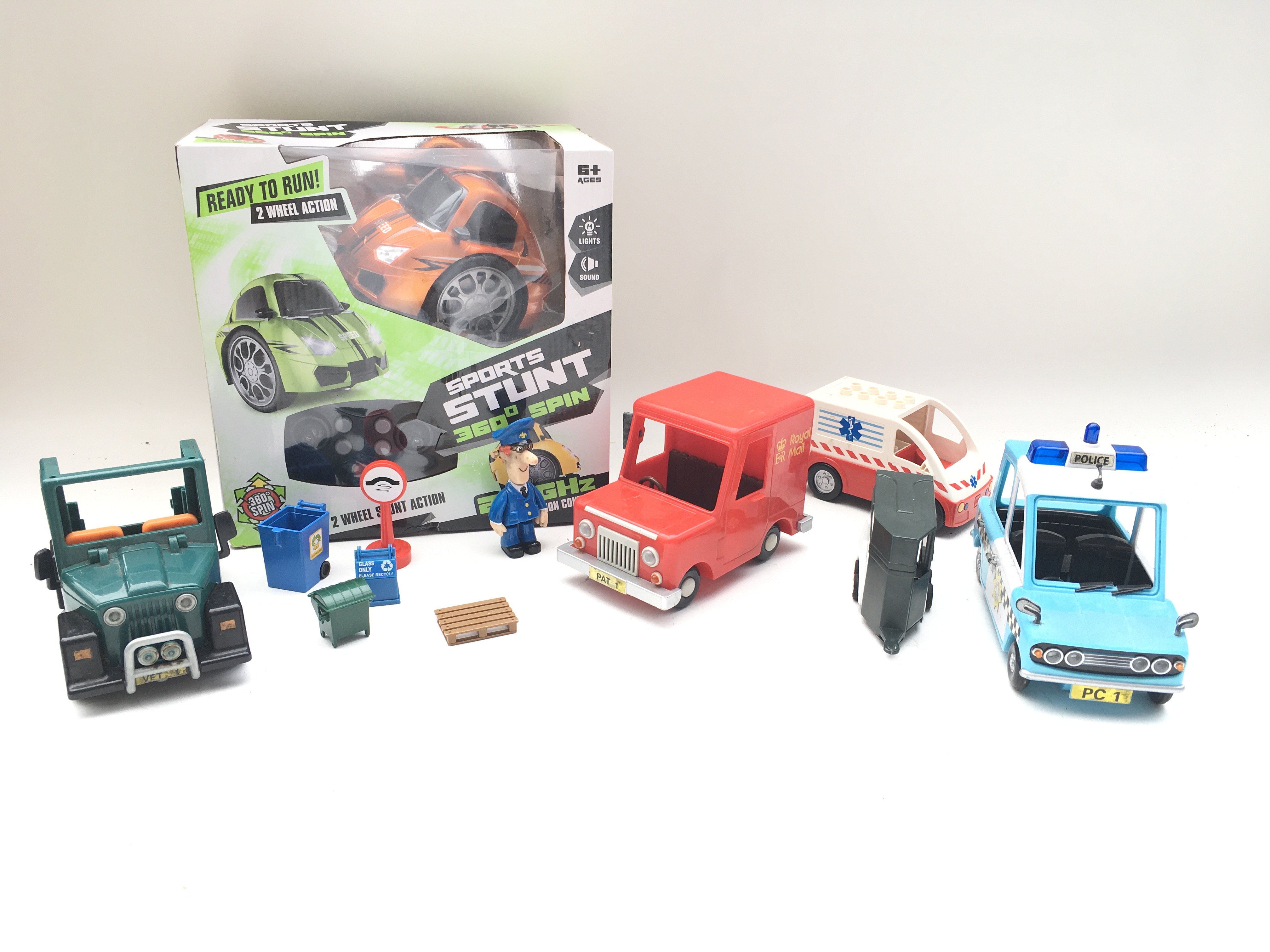 Collection of postman pat vehicles and figures. Boxed RC stunt car.