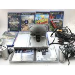 A Sony PlayStation 2 Slim (Silver) with games and