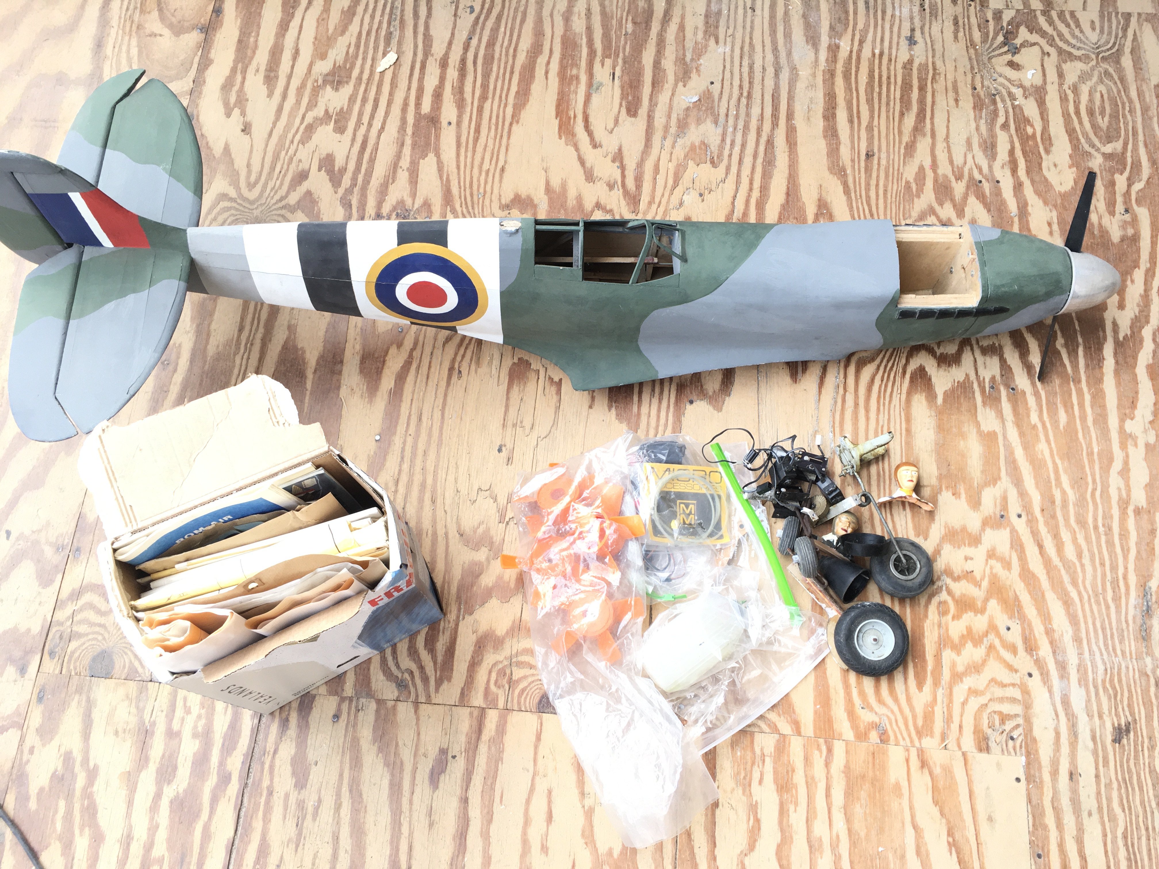 A incomplete Model spitfire with plans and Parts.