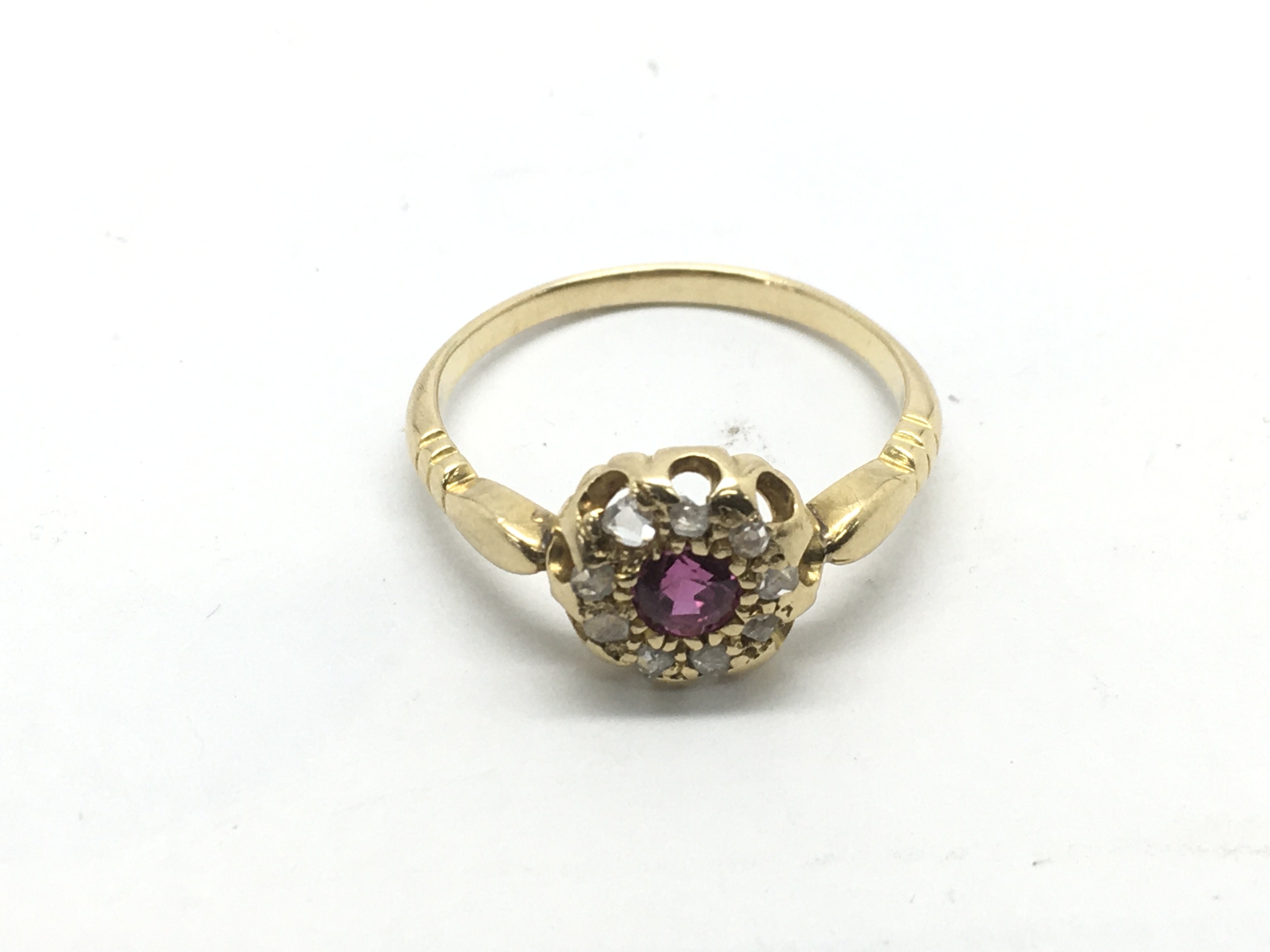 An 18ct gold, ruby and diamond cluster ring, appro