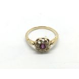 An 18ct gold, ruby and diamond cluster ring, appro