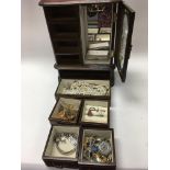 A collective lot of costume jewellery in a wooden jewellery case.