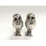A pair of silver cruets in the form of owls, appro
