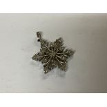 A small sterling silver snowflake pendant set with