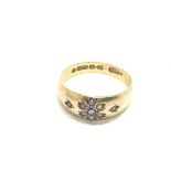 An antique gold ring set with a sapphire and small