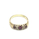 An 18carat gold ring set with ruby and small diamo