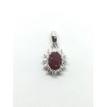 An 18ct white gold oval cut ruby and RBC diamond c