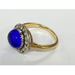 An 18ct gold ring set with a blue cabochon stone s