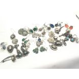 A collection of vintage silver earrings set with t