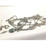 A collection of silver necklaces and watch chains