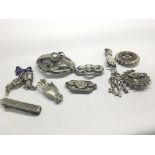 A collection of silver antique brooches in the for