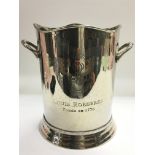 A silver plated champagne ice bucket.