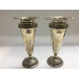 A pair of silver vases of tapering form, London hallmarks, approx 19.5cm.