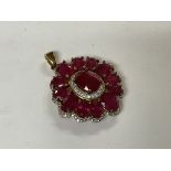 A sterling silver gilt ruby and white stone pendan