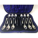 A cased set of 12 silver spoons and tongs Sheffiel