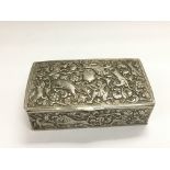 An Indian white metal box with elaborate hunting decoration, approx width 9cm.