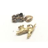 A cast 9ct gold charm in the form of a cat a small