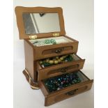 A small jewellery chest of drawers containing vint