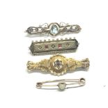 A collection of four gold bar brooches set with aq