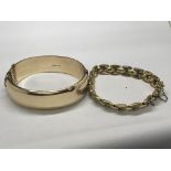 A 1/5 9ct gold bangle and one other gold tone brac
