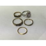 A collection of five rings including 22 ct band 2 grams two 9 ct inset with gem stones and two dress