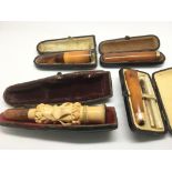 A collection of cheroot holders including one gold