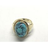 A 15ct gold ring set with a Turquoise cabochon rin