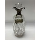 A hallmarked silver and cut glass topped Decanter.