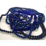A collection of Vintage blue bead necklaces includ
