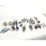 A collection of vintage silver earrings decorated