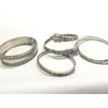 An antique silver bangle set with polished stones